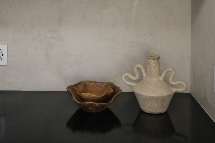 Shelves with ceramic items against a neutral wall
